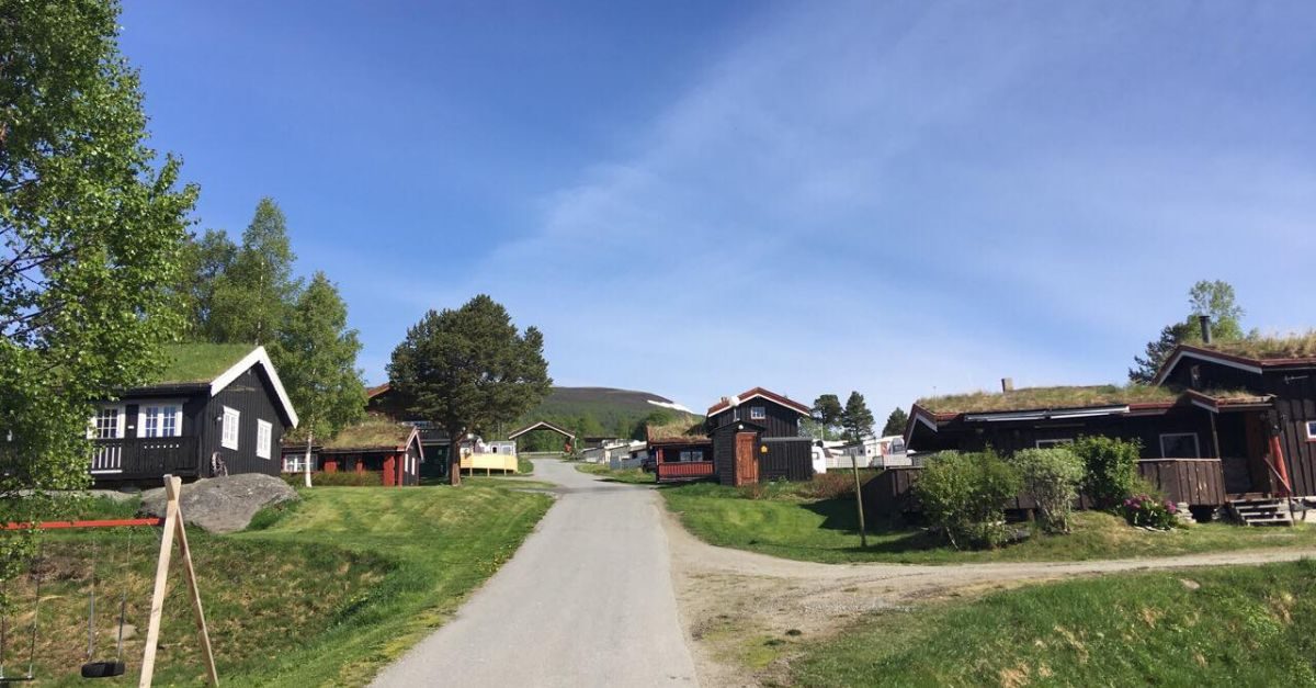 Breesgaard Camping ved foten av Storhornet med campingvogner og fjellutsikt vest for Oppdal